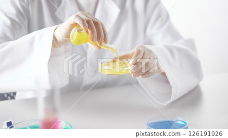 Hands Performing Scientific Experiments in a Modern Laboratory Setting. Hands Performing Scientific Experiments in a Modern Laboratory Setting. 126191926