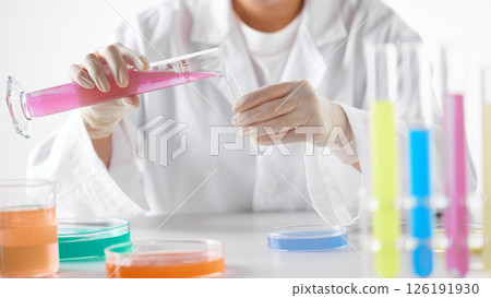 Hands Performing Scientific Experiments in a Modern Laboratory Setting. Hands Performing Scientific Experiments in a Modern Laboratory Setting. 126191930