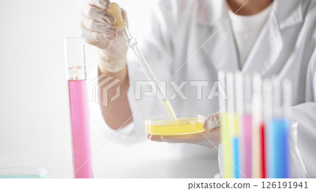 Hands Performing Scientific Experiments in a Modern Laboratory Setting. 126191941