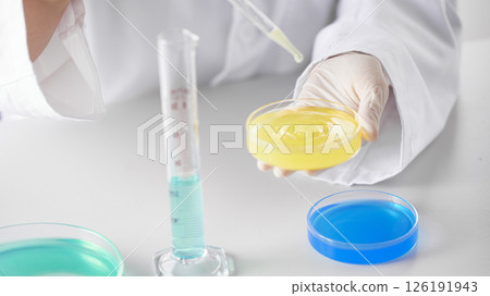 Hands Performing Scientific Experiments in a Modern Laboratory Setting. 126191943