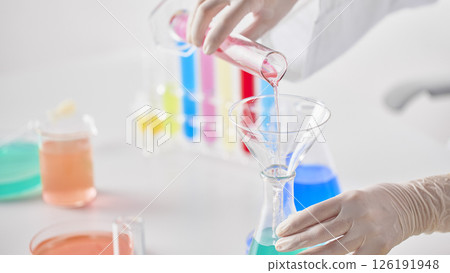Hands Performing Scientific Experiments in a Modern Laboratory Setting. 126191948