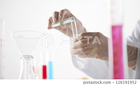 Hands Performing Scientific Experiments in a Modern Laboratory Setting. 126191952