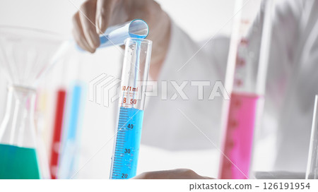 Hands Performing Scientific Experiments in a Modern Laboratory Setting. Hands Performing Scientific Experiments in a Modern Laboratory Setting. 126191954