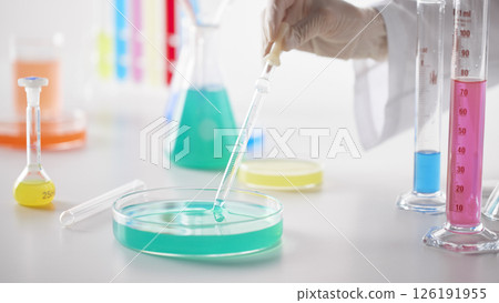 Hands Performing Scientific Experiments in a Modern Laboratory Setting. 126191955