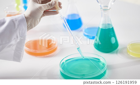 Hands Performing Scientific Experiments in a Modern Laboratory Setting. Hands Performing Scientific Experiments in a Modern Laboratory Setting. 126191959