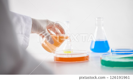 Hands Performing Scientific Experiments in a Modern Laboratory Setting. 126191961