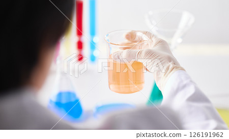 Hands Performing Scientific Experiments in a Modern Laboratory Setting. 126191962