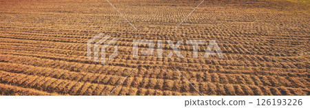 Plowed arable field background. Rural landscape. Horizontal banner 126193226