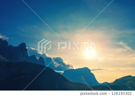 Silhouette of rocks against the sunset sky. Mountain landscape background. Rocks against the day sky. The dolomites in South Tyrol, Italy, Europe Silhouette of rocks against the sunset sky. Mountain landscape background. Rocks against the day sky. The dolomites in South Tyrol, Italy, Europe 126193302