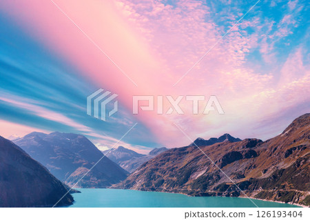 Top view of a mountain lake Kolnbreinspeicher at sunset. Gamskarnock, Austria Europe Top view of a mountain lake Kolnbreinspeicher at sunset. Gamskarnock, Austria Europe 126193404