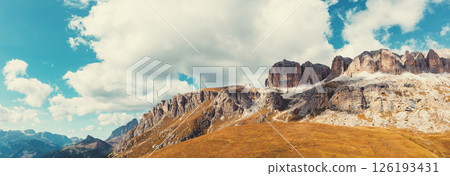 Panoramic view of the mountain landscape in autumn. Piz Boe, Sella Towers. Pordoi Pass in the Dolomites, South Tyrol, Italy.  Horizontal banner 126193431