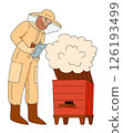 Man beekeeper in protective suit holding fumigating bee hive with smoke 126193499