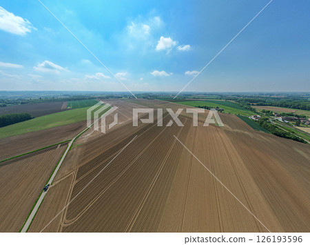 Stunning Aerial View of a Beautiful Agricultural Landscape Under Clear Blue Sky and Sunshine Stunning Aerial View of a Beautiful Agricultural Landscape Under Clear Blue Sky and Sunshine 126193596