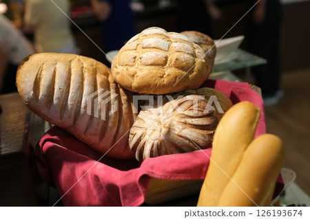Assortment of freshly baked breads. Buns and croissants. 126193674