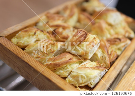 fresh bagels with butter and cheese on plate and cup of coffee on ceramic background fresh bagels with butter and cheese on plate and cup of coffee on ceramic background 126193676