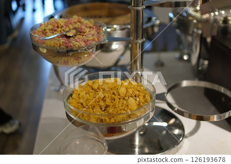 Cereal breakfast buffet Breakfast served with coffee, orange juice, croissants, cereals and fruits. Balanced diet. Cereal breakfast buffet Breakfast served with coffee, orange juice, croissants, cereals and fruits. Balanced diet. 126193678
