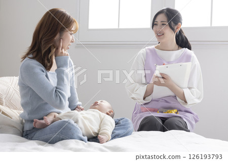 Mother and nurse holding baby Mother and nurse holding baby 126193793