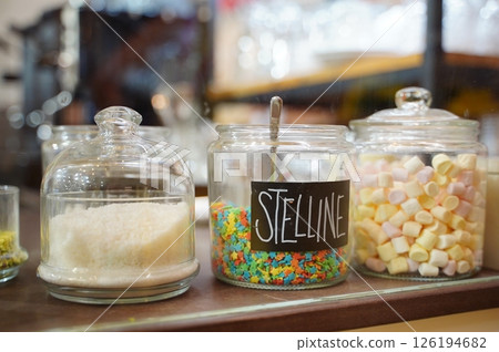 Colorful Candy Jars with Stelline and Marshmallows Display Colorful Candy Jars with Stelline and Marshmallows Display 126194682