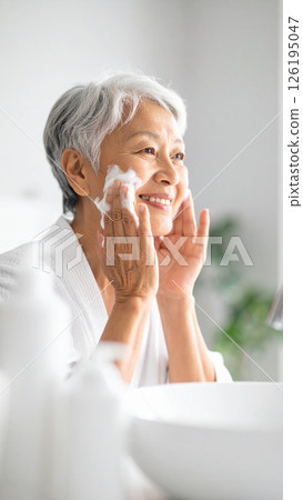 Senior woman washing her face (AI-generated image) Senior woman washing her face (AI-generated image) 126195047