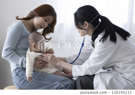 Female doctor examining a baby 126195215