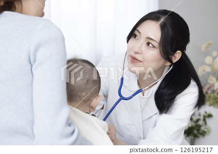 Female doctor examining a baby 126195217