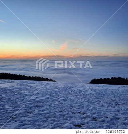 Winter sunset landscape, a ski track in the snow, mountains of the Wasserkuppe. Wasserkuppe, in Hesse, Germany. Traveling to the mountains in the winter. 126195722