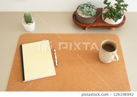Minimal home office desk with notebook, coffee mug, and succulent plants Minimal home office desk with notebook, coffee mug, and succulent plants 126196942