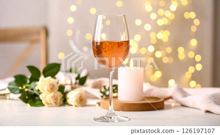 Rose wine glasses with bokeh lights and candles placed on the table, party concept Rose wine glasses with bokeh lights and candles placed on the table, party concept 126197107