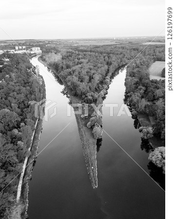 Aerial view showcasing the striking confluence of the Vltava and Labe rivers near Melnik in Czechia. This unique landscape reveals the meeting point of two significant waterways. Aerial view showcasing the striking confluence of the Vltava and Labe rivers near Melnik in Czechia. This unique landscape reveals the meeting point of two significant waterways. 126197699