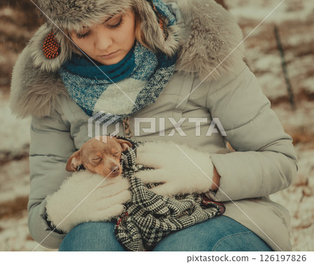 Sad girl hug warming her dog in cold day 126197826