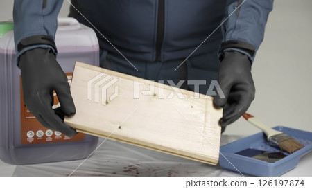 A person engages in a woodworking project, showcasing creativity. Creative 126197874