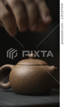 This is an Elegant Teapot featuring a Minimalist Design that enhances any tea experience. Media 126197939