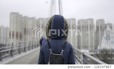 Woman walking on bridge as people approach from distance. Action Woman walking on bridge as people approach from distance. Action 126197967