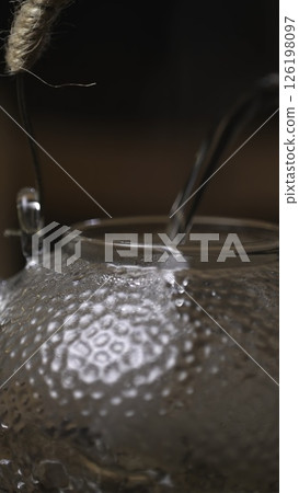 An Elegant Teapot with Water Pouring is a stunning representation of artistry in design. Media 126198097