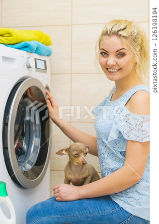 Woman setting washing machine 126198194