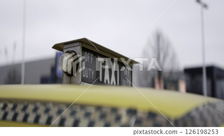 Yellow taxi sign showing off duty status. Action 126198253