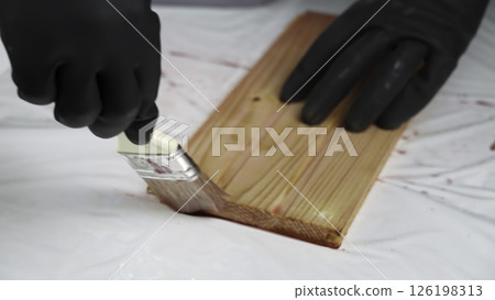 Meticulously Painting a Wooden Surface with Careful Attention to Detail and Protection. Creative 126198313