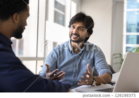 Indian businessman leads formal conversation with company client Indian businessman leads formal conversation with company client 126198373