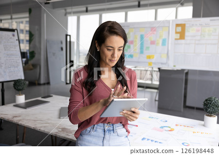 Young businesswoman use digital tablet in creative modern office boardroom 126198448