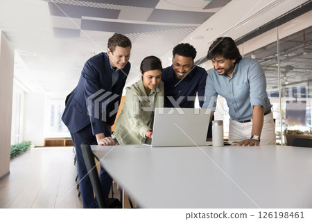 Four multinational businesspeople tracking sales results using laptop 126198461