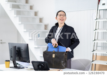 A female employee of a construction company preparing to depart 126198470