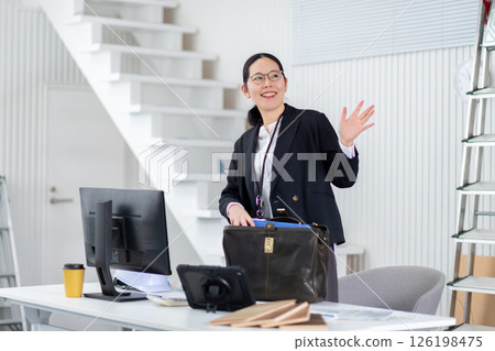 A female employee of a construction company preparing to depart 126198475