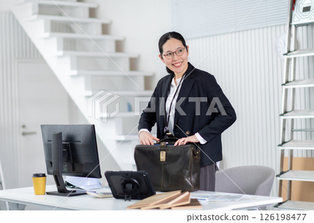 A female employee of a construction company preparing to depart 126198477
