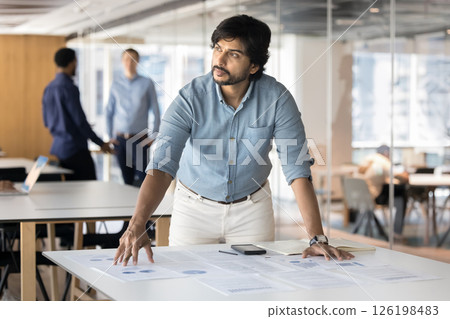 Businessman look thoughtfully into distance, analyzing data, making strategic decision Businessman look thoughtfully into distance, analyzing data, making strategic decision 126198483