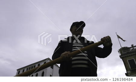 Gondolier rowing gondola in venice canal. Action Gondolier rowing gondola in venice canal. Action 126198484