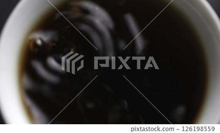 Carefully pouring a delicious beverage into a cup, creating an inviting and cozy atmosphere. Media Carefully pouring a delicious beverage into a cup, creating an inviting and cozy atmosphere. Media 126198559