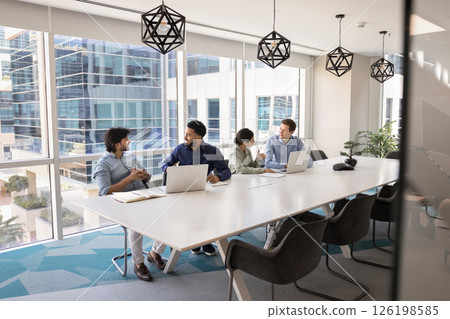 Diverse businesspeople lead formal talk seated at table in boardroom 126198585