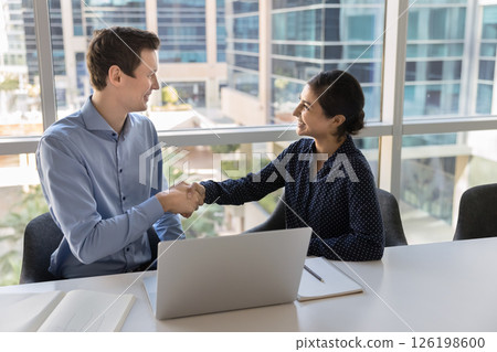 Happy colleagues shaking hands finish meeting in contemporary corporate office 126198600