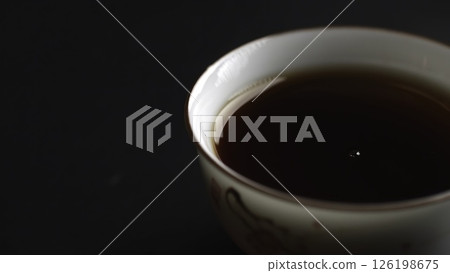 An Elegant Tea Pouring Gracefully into a Beautiful Traditional Cup Ready for Enjoyment. Media An Elegant Tea Pouring Gracefully into a Beautiful Traditional Cup Ready for Enjoyment. Media 126198675