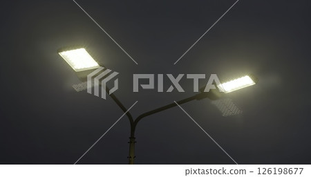 The illuminated street lamps stand out beautifully against the darkened sky at night. Media The illuminated street lamps stand out beautifully against the darkened sky at night. Media 126198677